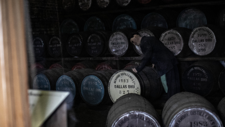Dark warehouse with casks of Dallas Dhu. A mannequin is dressed as a warehouse employee.